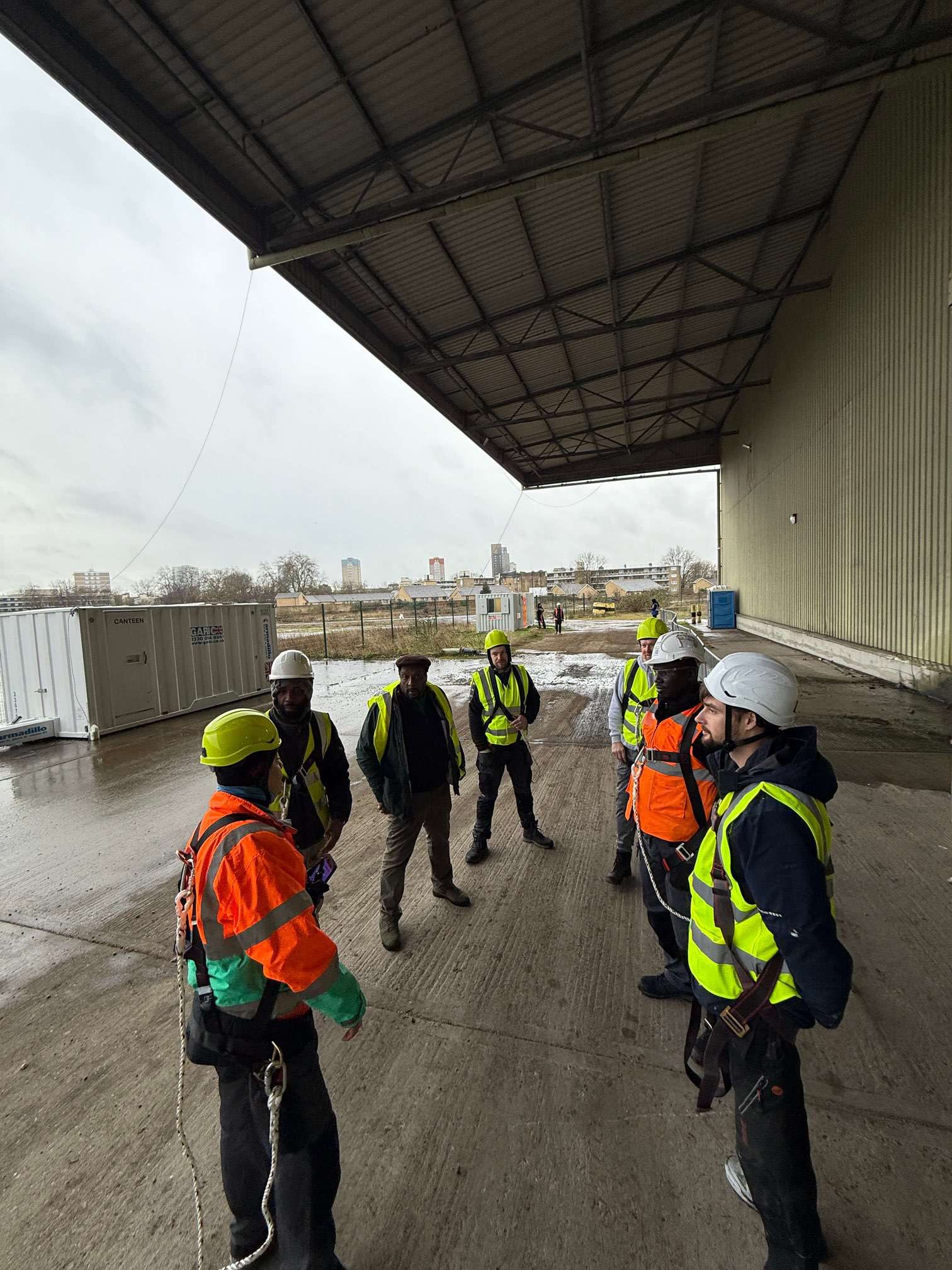 Site team gathered beneath the external canopy at Deptford Store House