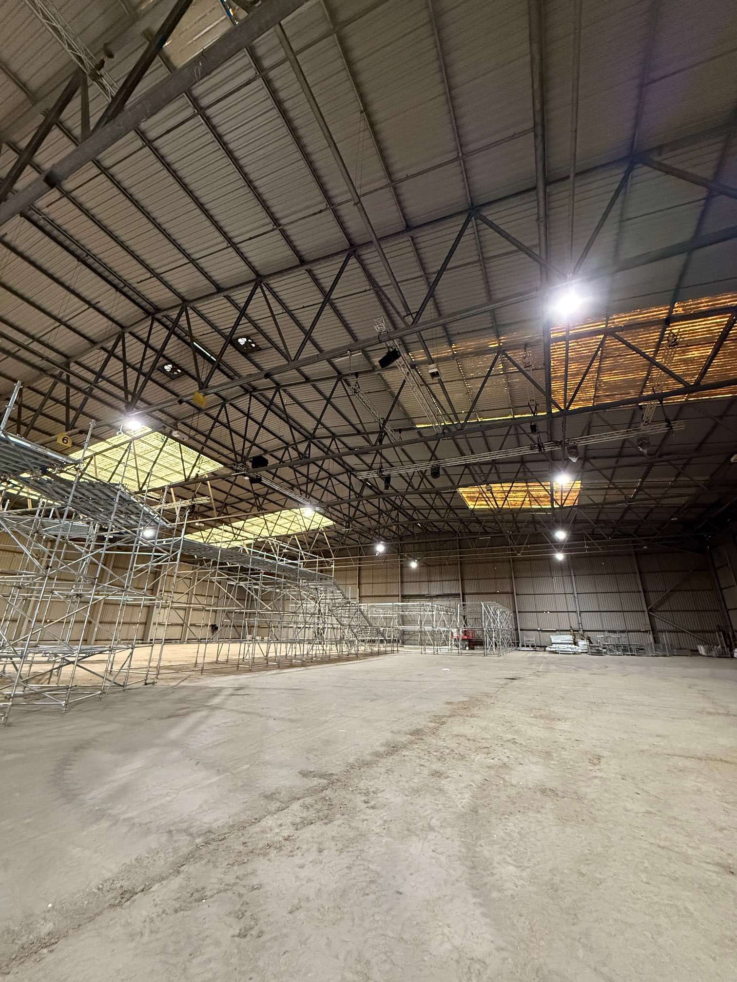 Warehouse floor and scaffolding beneath the steel roof structure