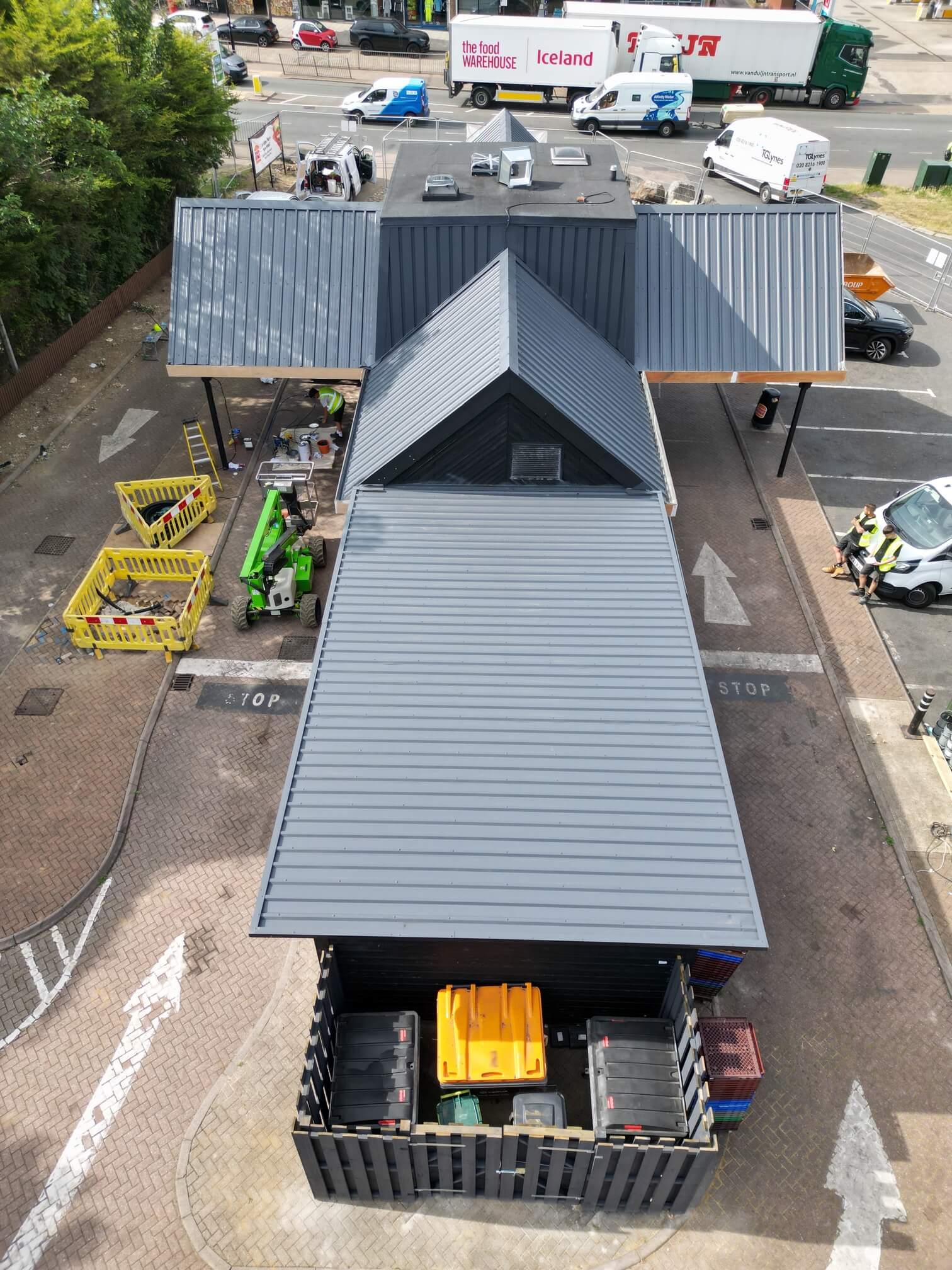 Aerial view along the grey roof of a Burger King restaurant, with access equipment at the side.