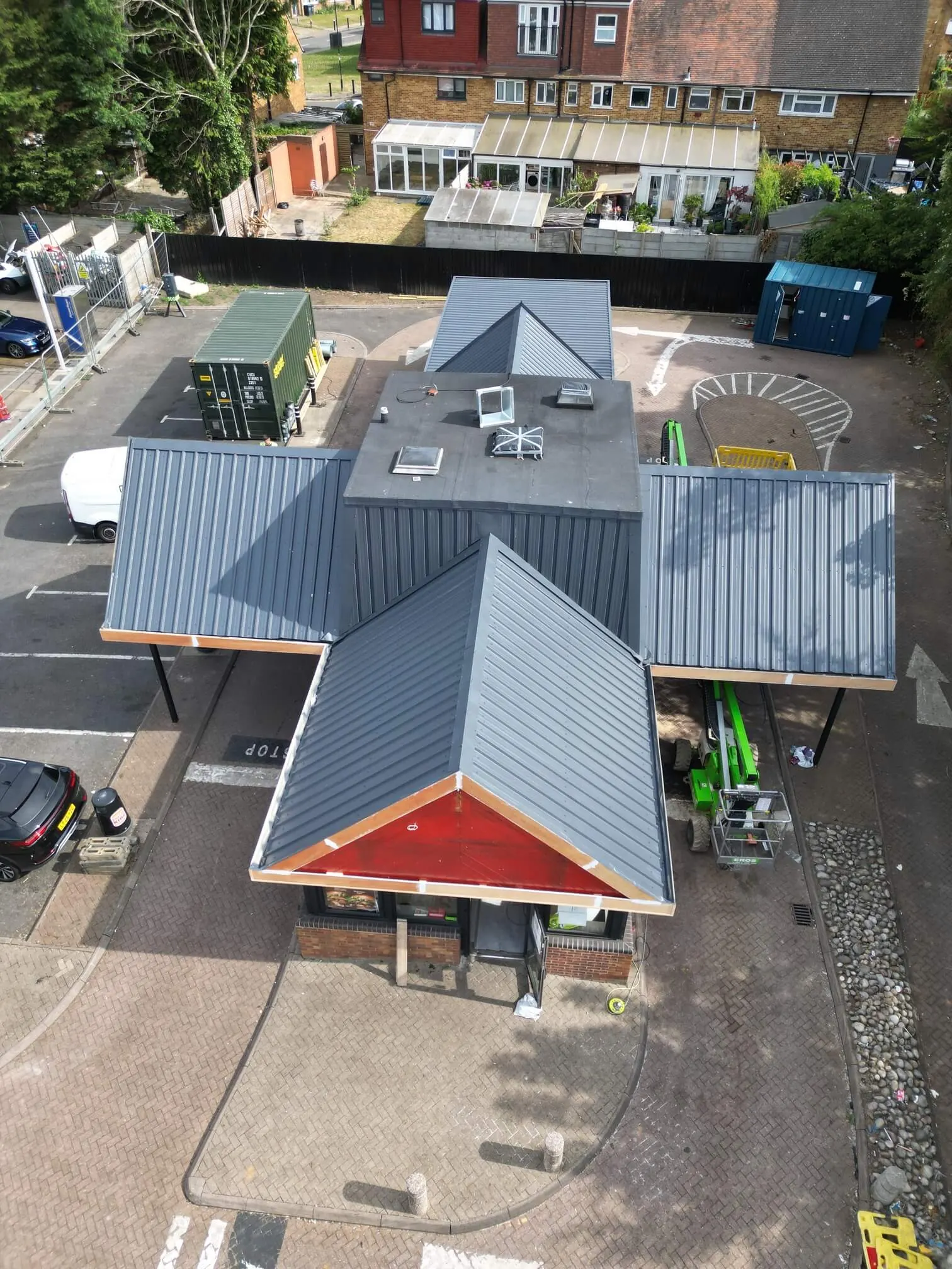 Front aerial view of a Burger King restaurant with dark grey roof slopes and a central plant enclosure.