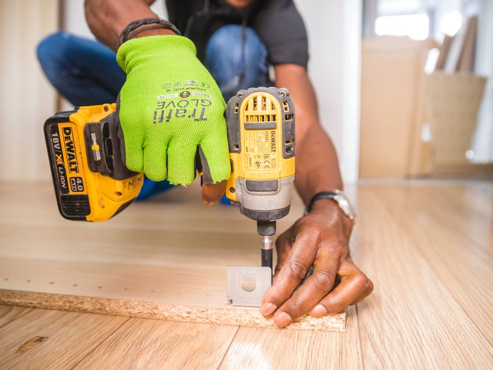 Handyman hammering nail into wood