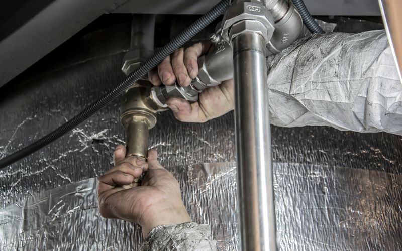 Plumber hands installing pipe fittings