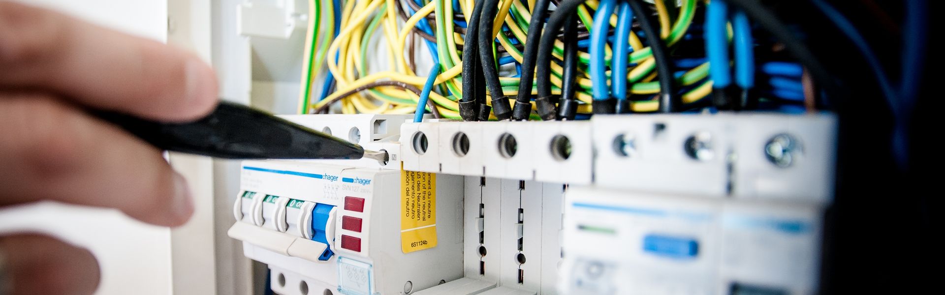Electrician working on circuit breaker panel