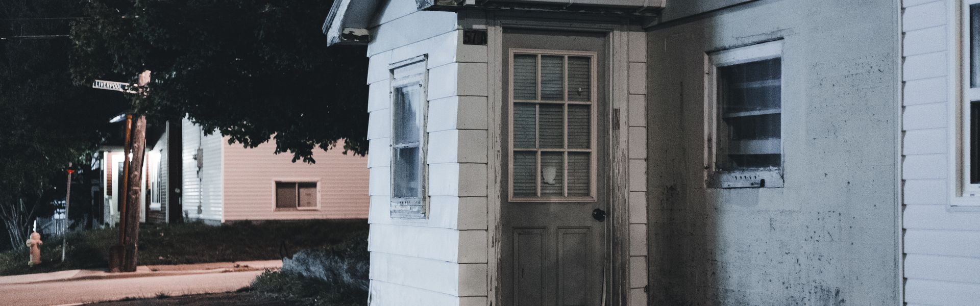 House entrance with wooden door at dusk