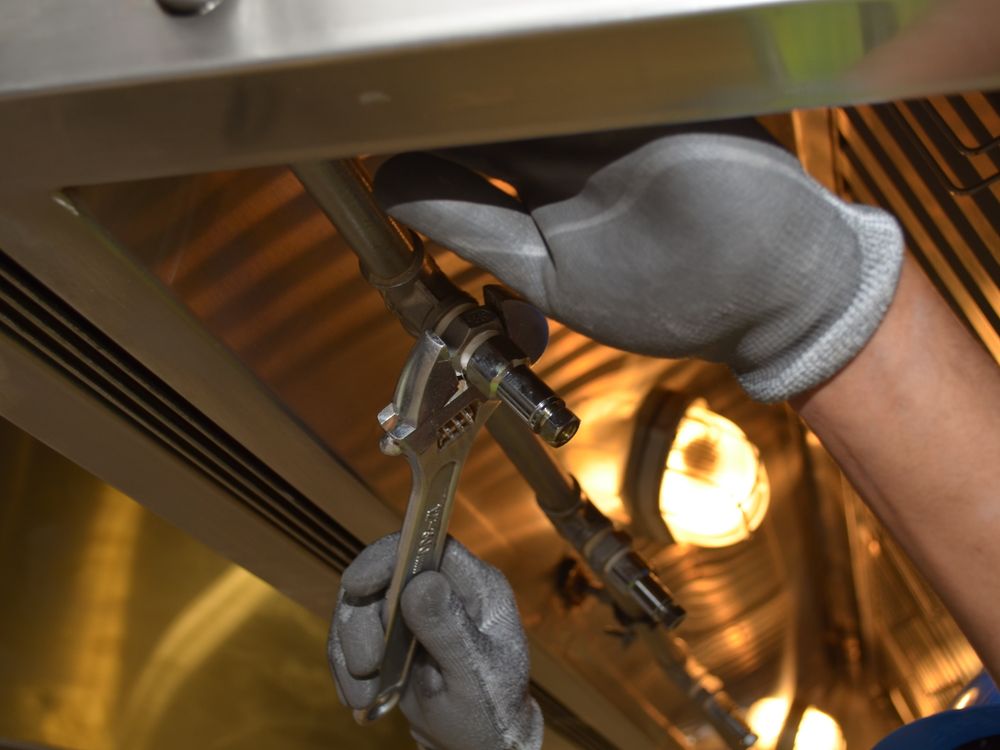 Technician repairing fixture with a spanner
