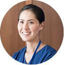 A woman in blue scrubs