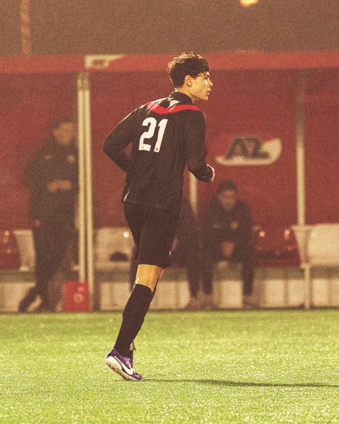 Walt Brender playing soccer in the number 21 shirt