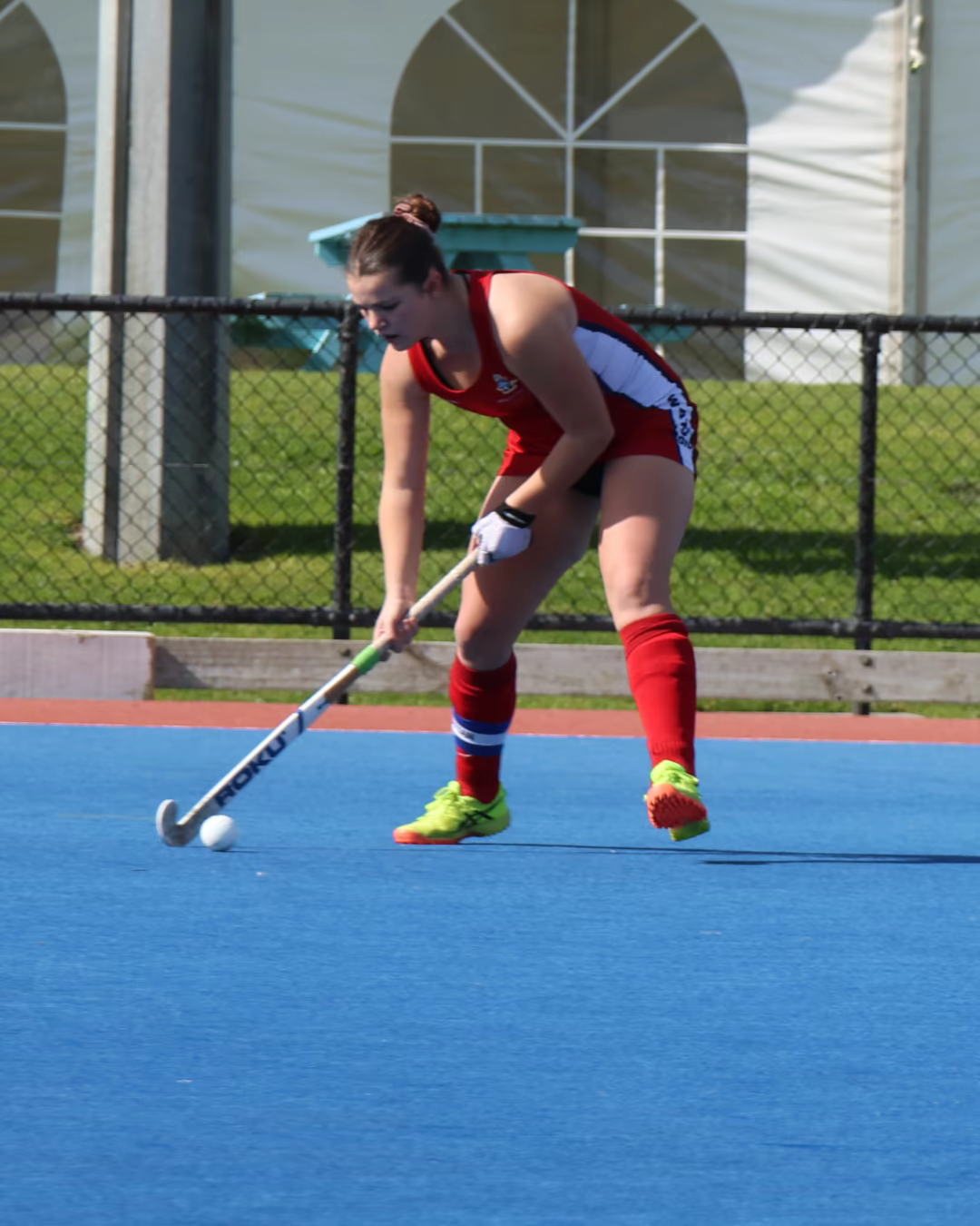 Natalie Carter controlling the ball during a field hockey match