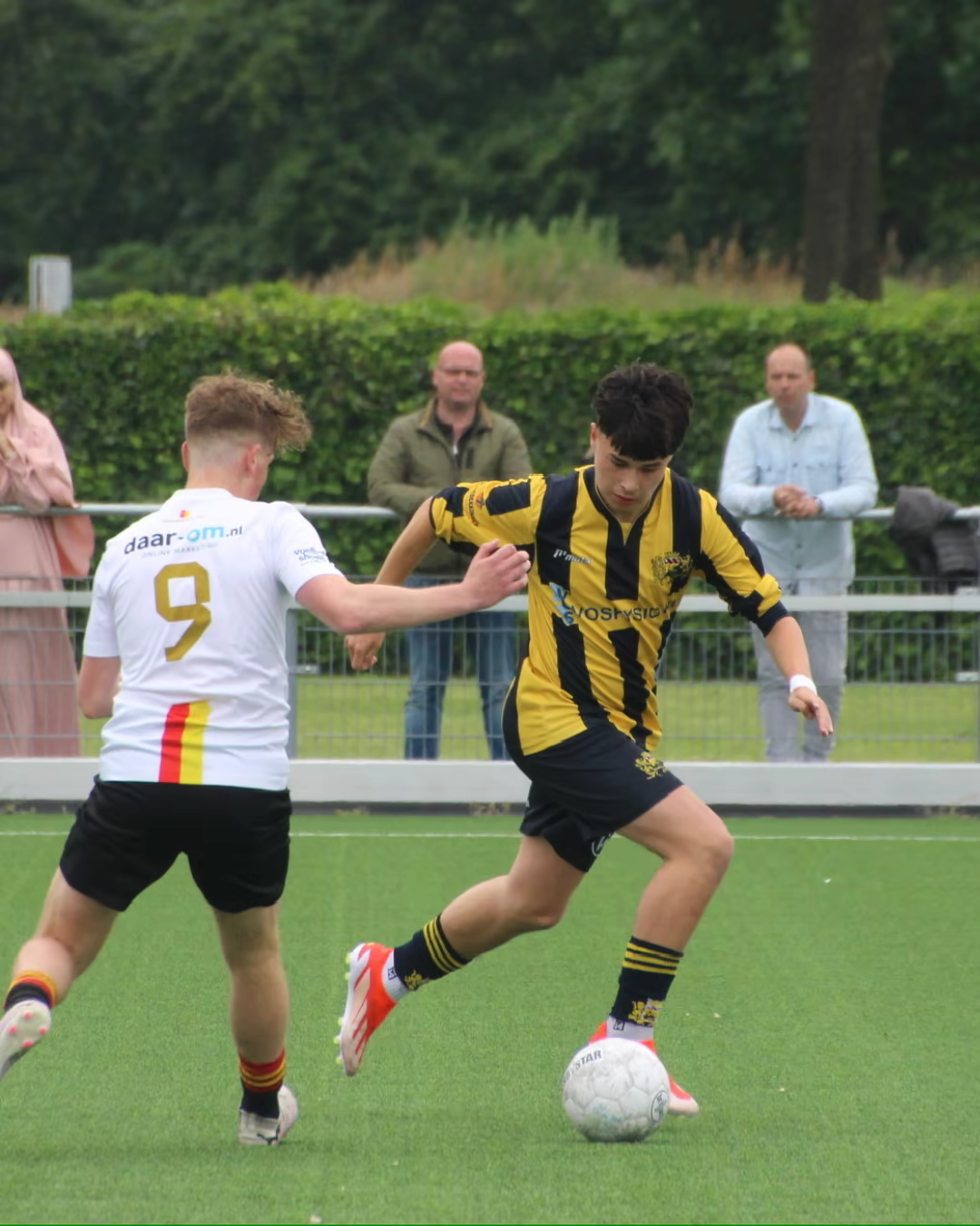 Ryan Pham dribbling past an opponent during a soccer match