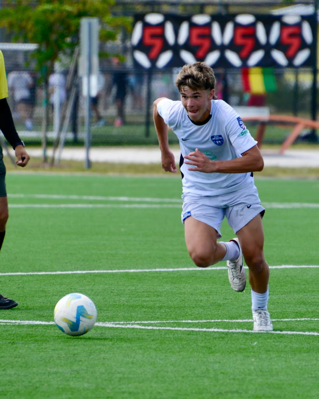Luciano Zuniga sprinting toward the ball during a soccer match