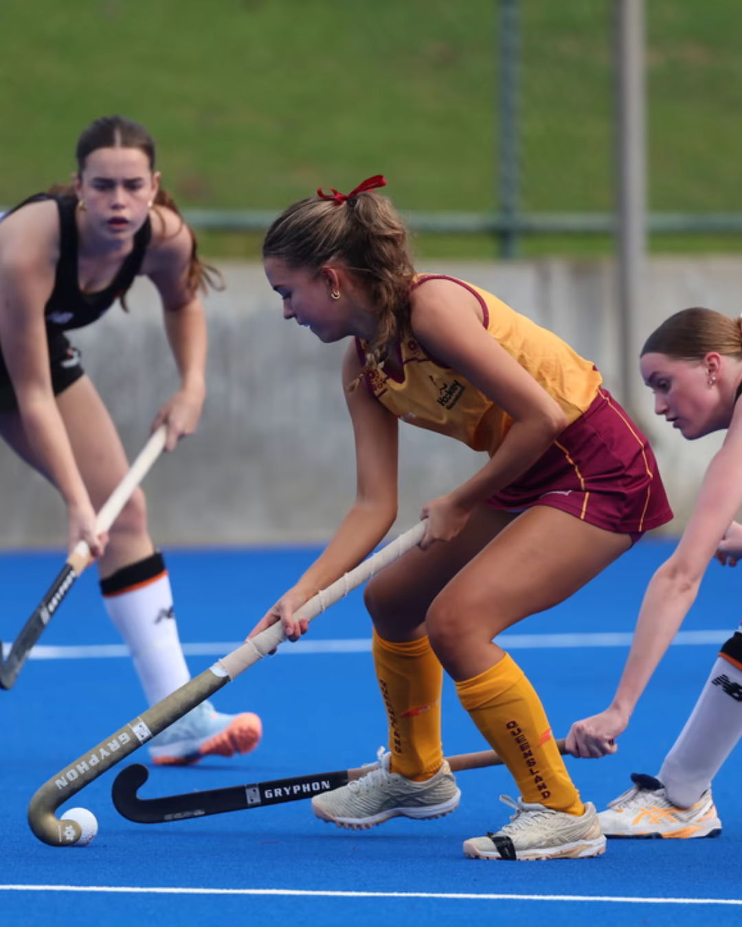Hayley Davis controlling the ball during a field hockey match
