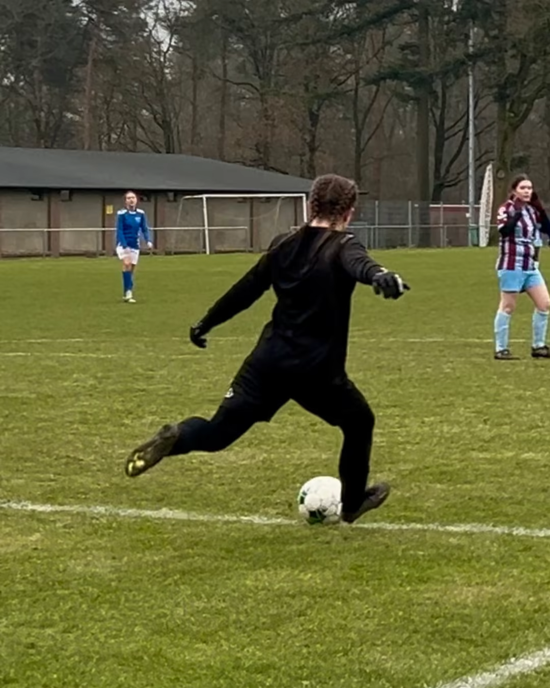 Julie van de Veen kicking the ball during a soccer match