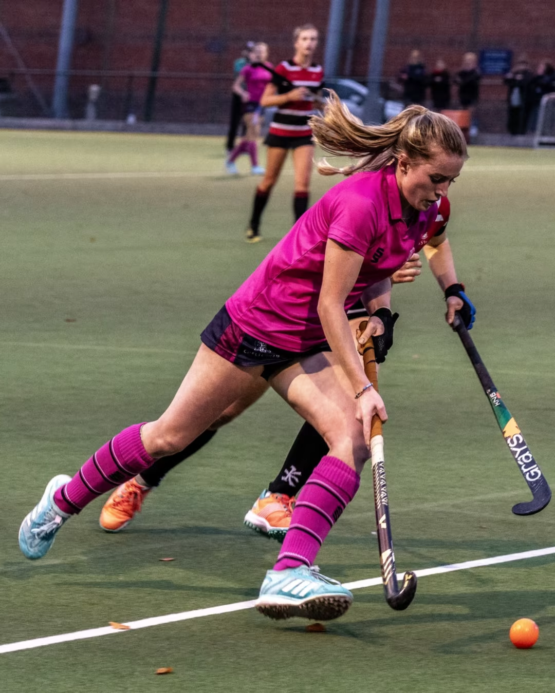 Evie Henderson controlling the ball during a field hockey match