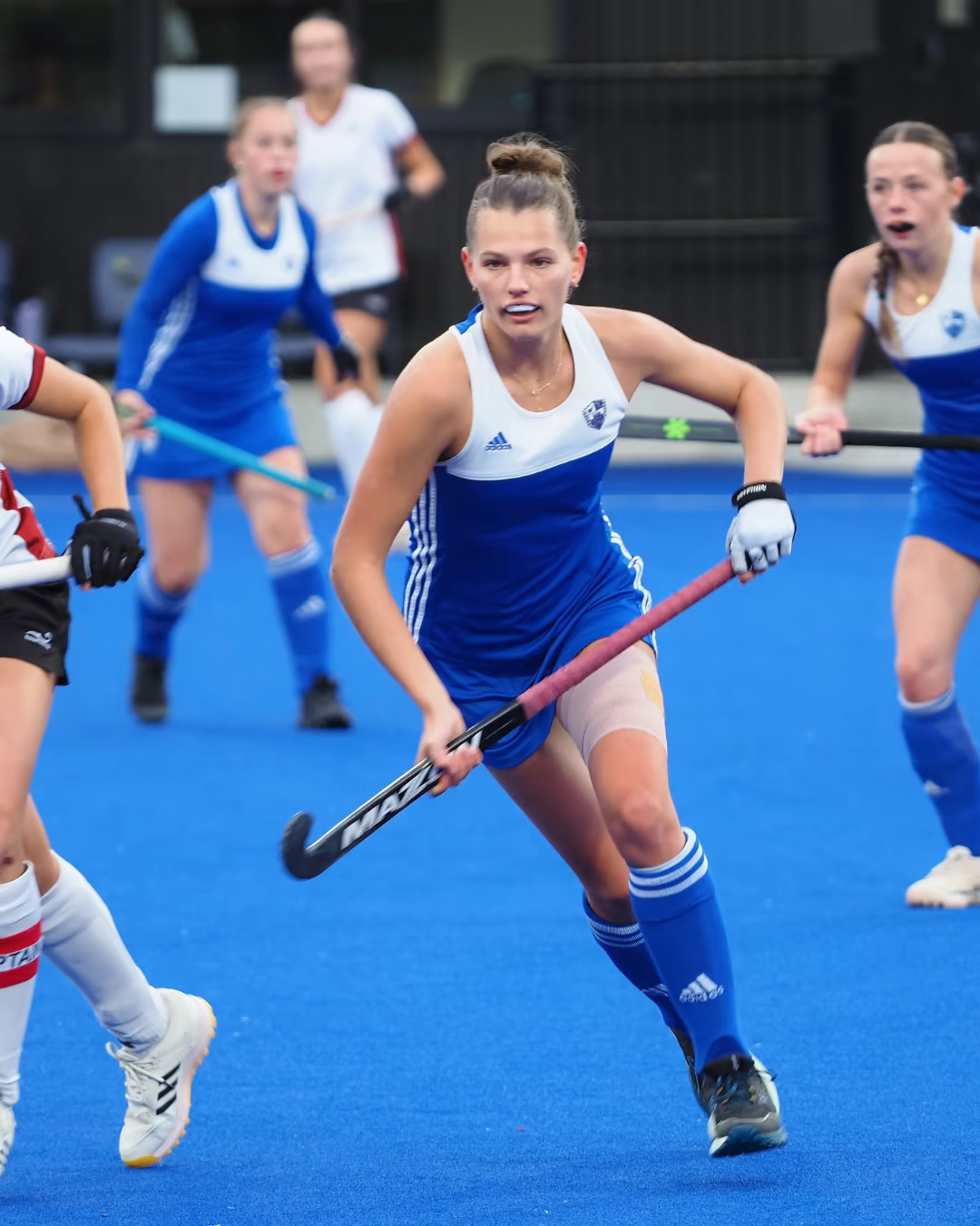 Livvy Barker carrying the ball during a field hockey match