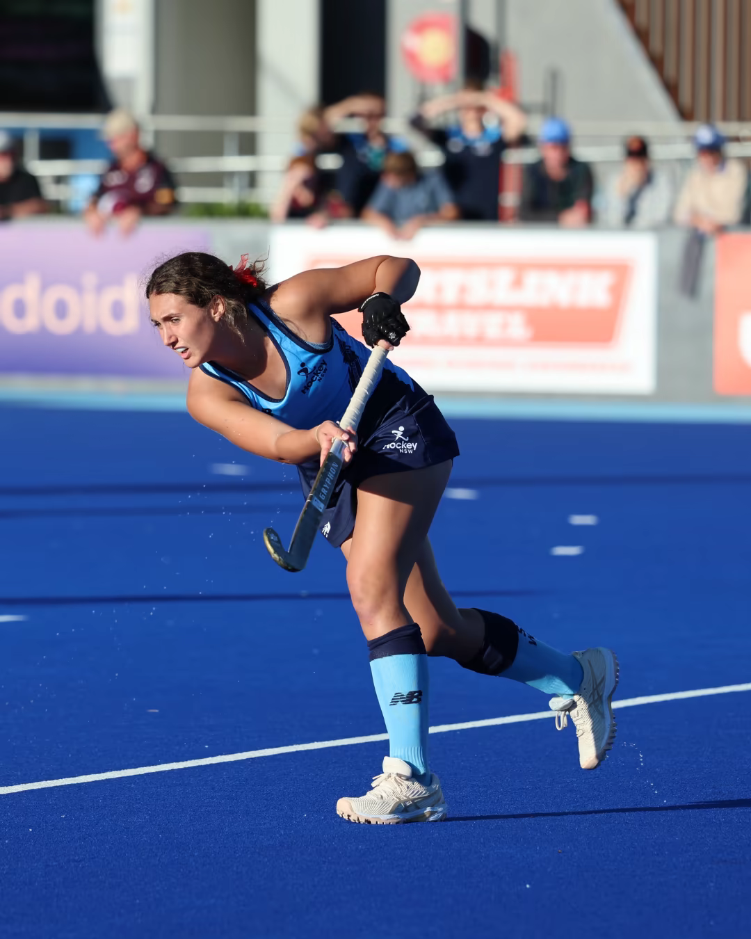 Maia Adamson playing field hockey