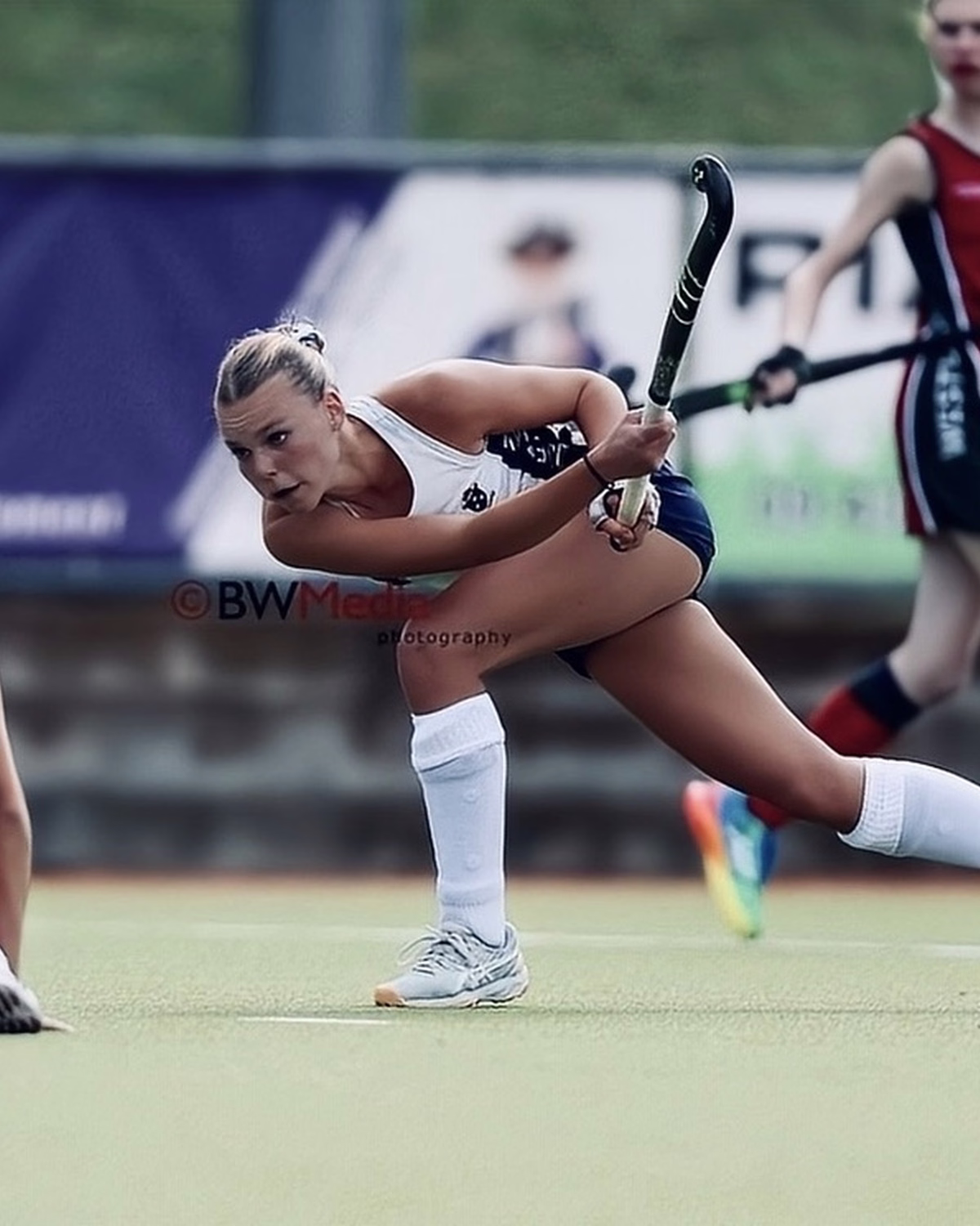 Isla Barker reaching for the ball during a field hockey match