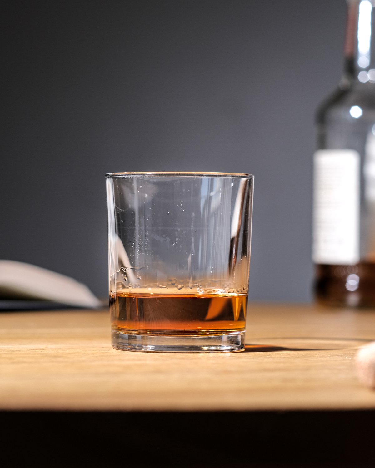 Single malt whisky in a glass, bottle next to it