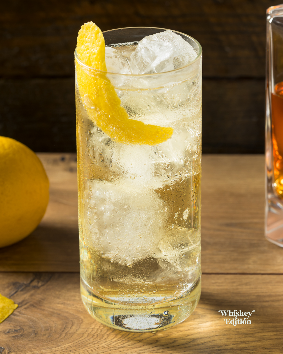 Whisky Highball in a tall glass over ice, garnished with lemon peel