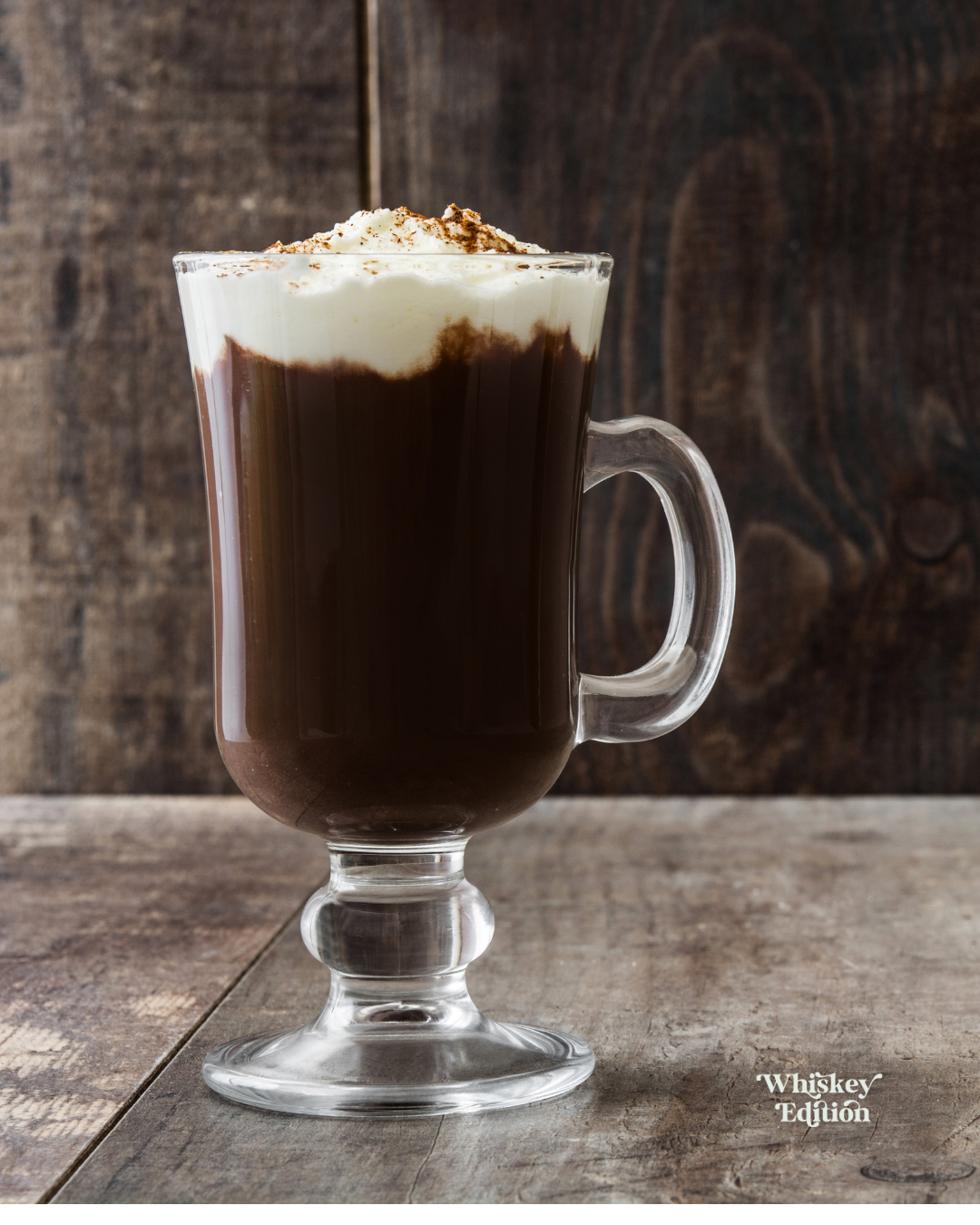 Irish Coffee in a stemmed glass, cream floated on top
