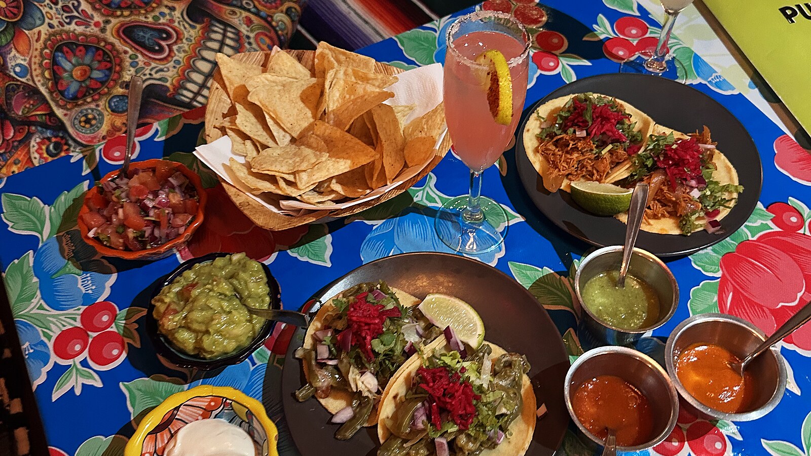 A full table at Pueblo Bar: tacos, guacamole, tortilla chips and the house salsas