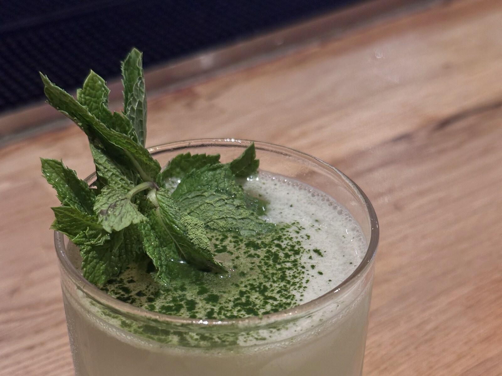 Mintchata seen from above, with mint and matcha powder on the foam