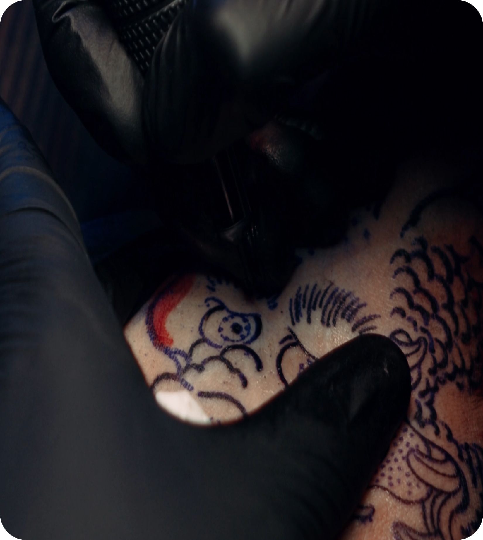 Tattoo artist working with protective gloves
