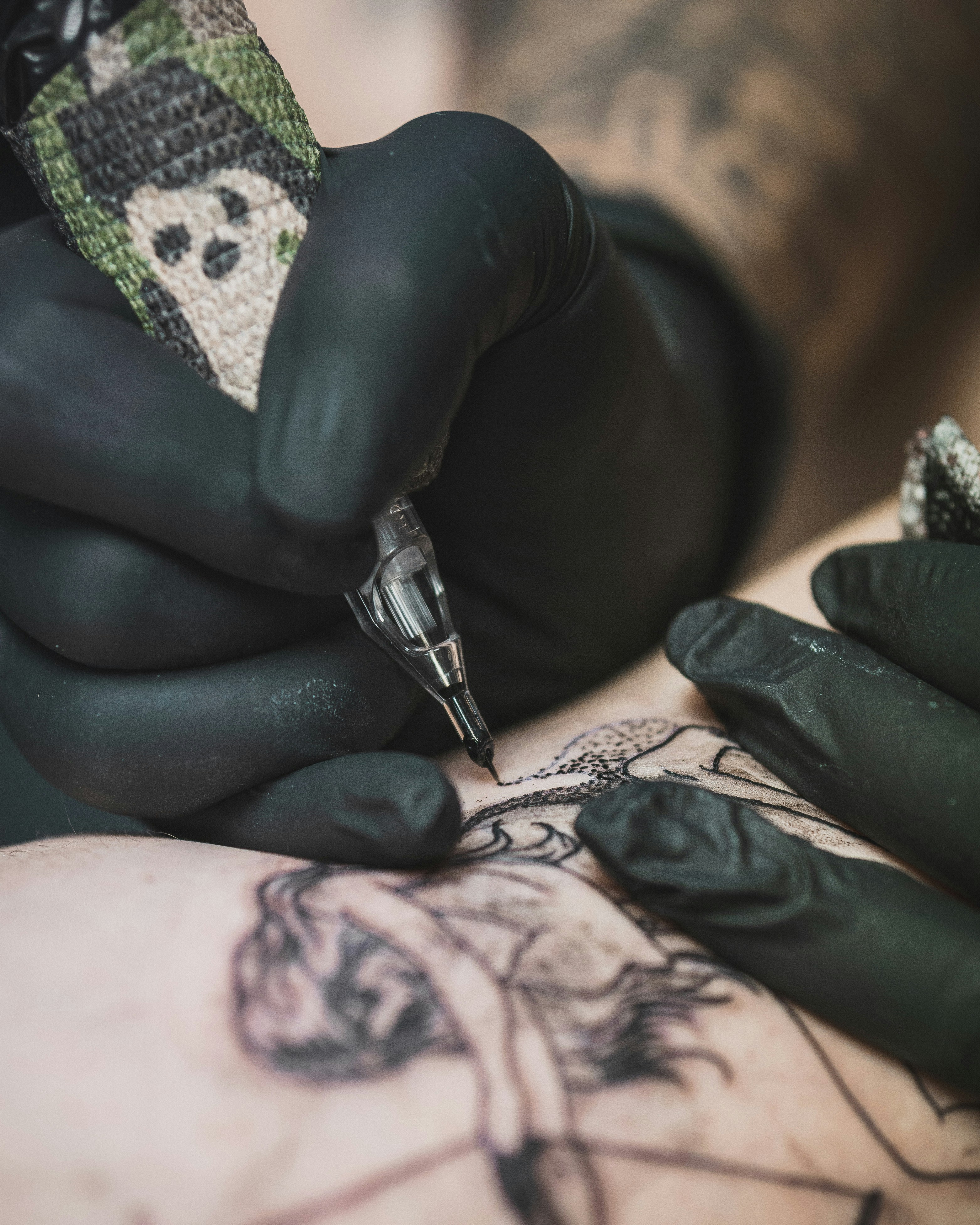 Tattoo artist wearing Aurelia Absolute gloves