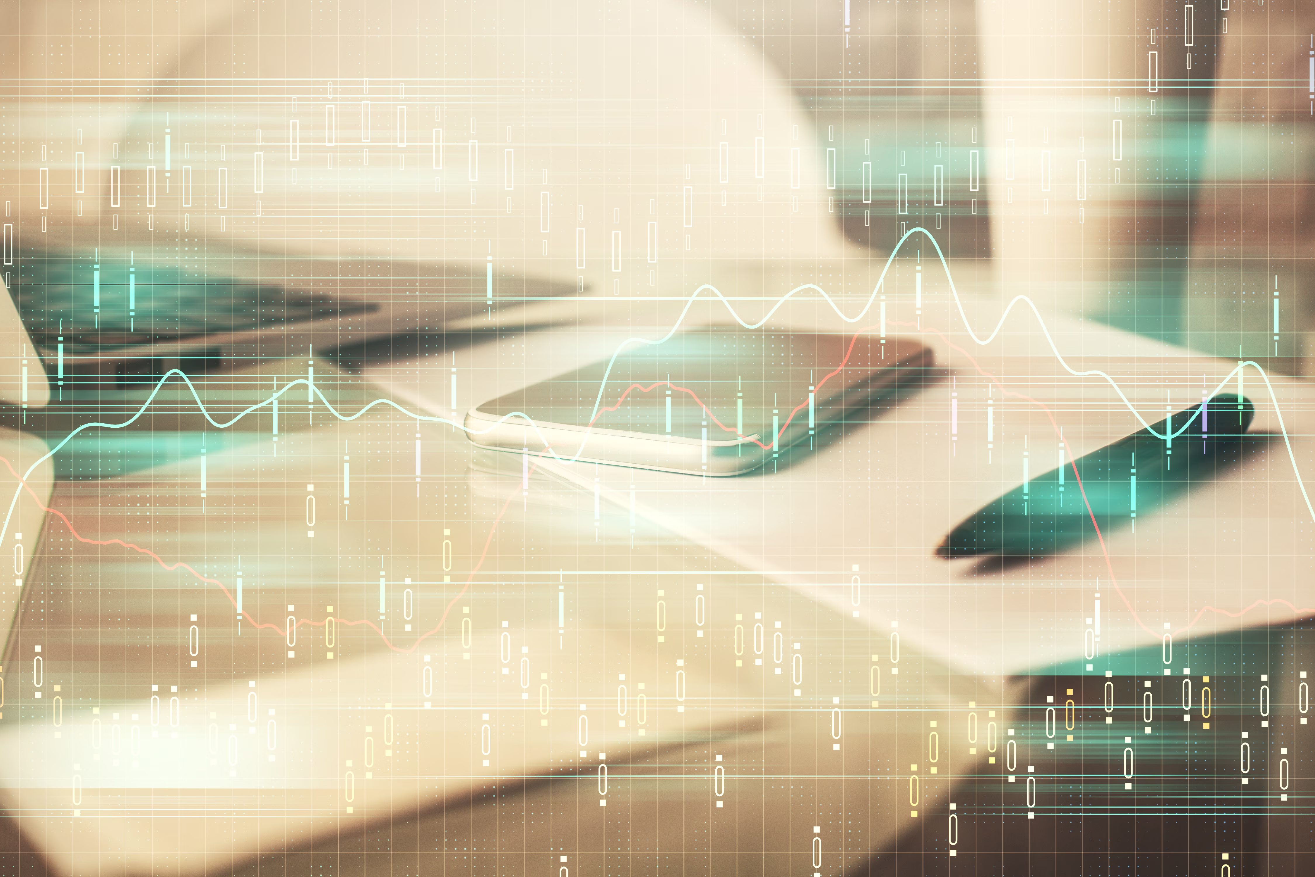 Smartphone and pen on paper with digital stock market graphs overlay on a workspace.