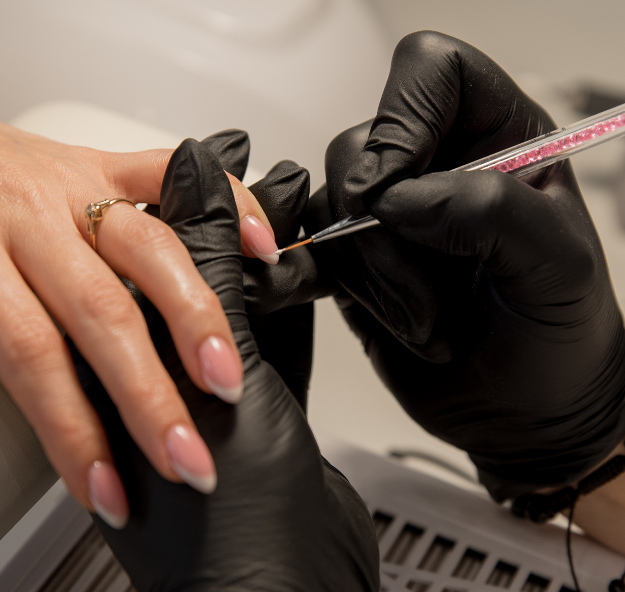 A technician using a precision tool during a gel manicure