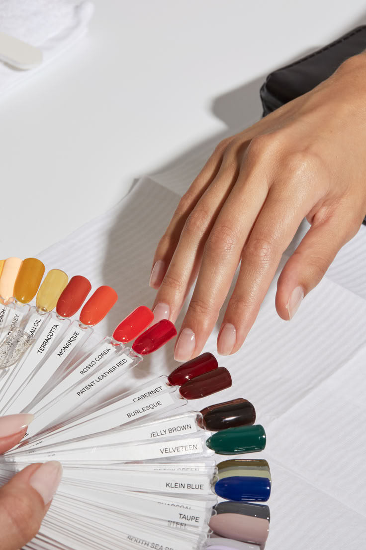 A guest browsing a fan of nail polish color samples