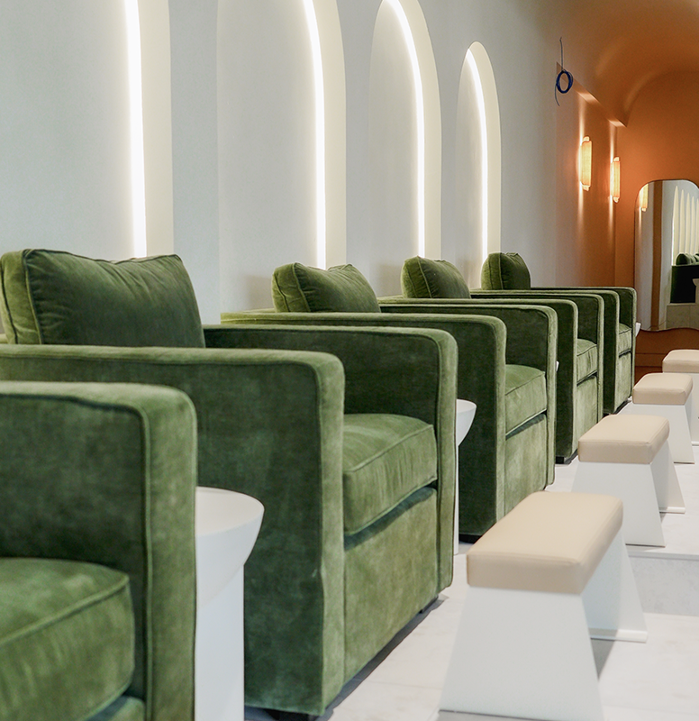 Pedicure seating beneath the studio's signature arches