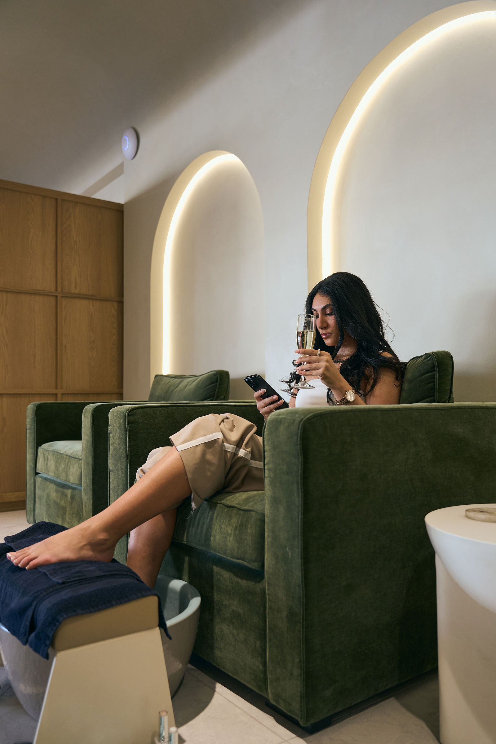 A guest relaxing in a pedicure chair