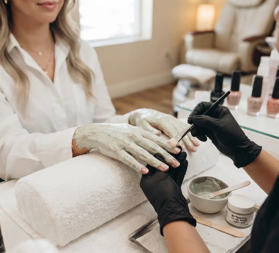A technician applying polish during a manicure