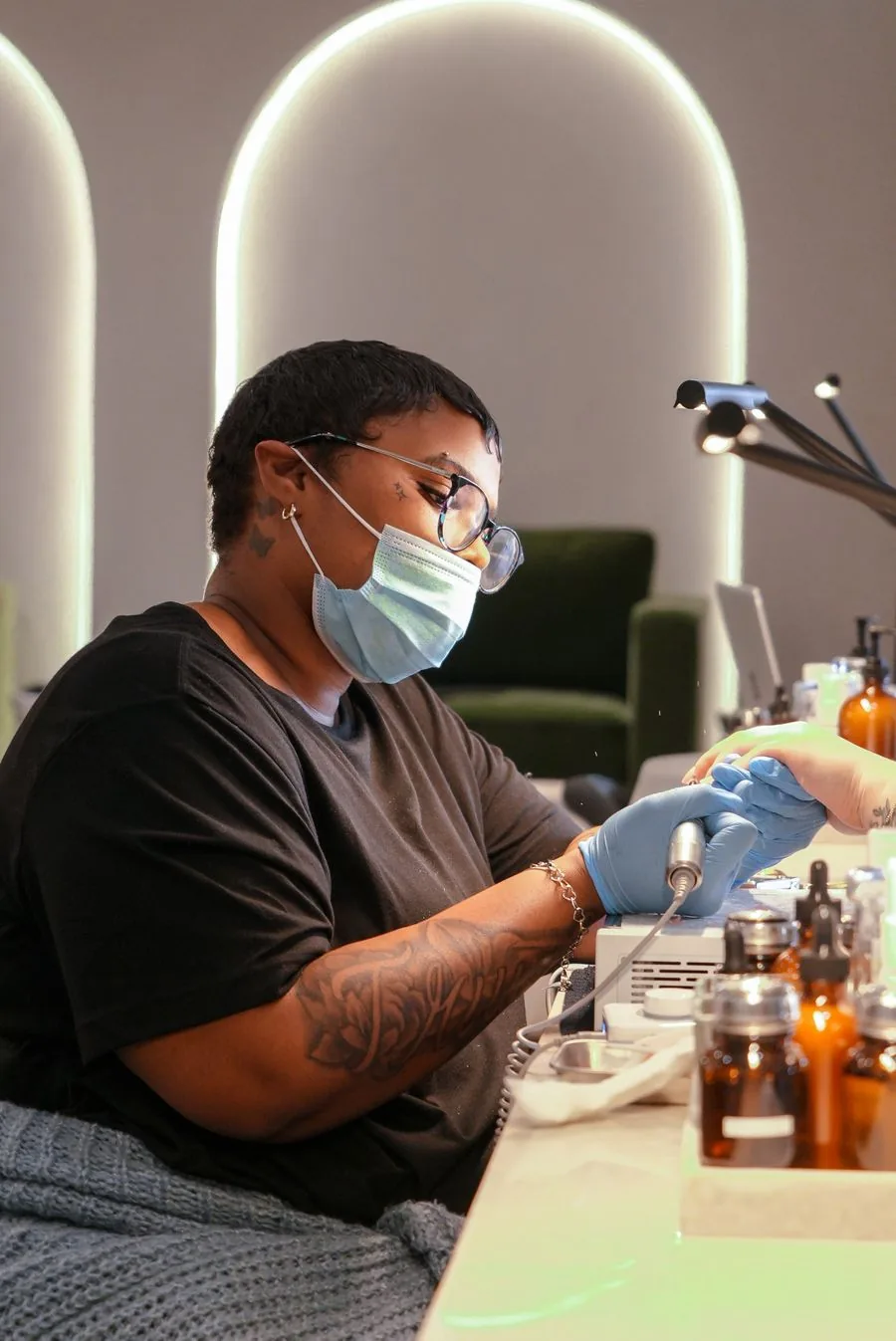 An Earth technician working at a nail station