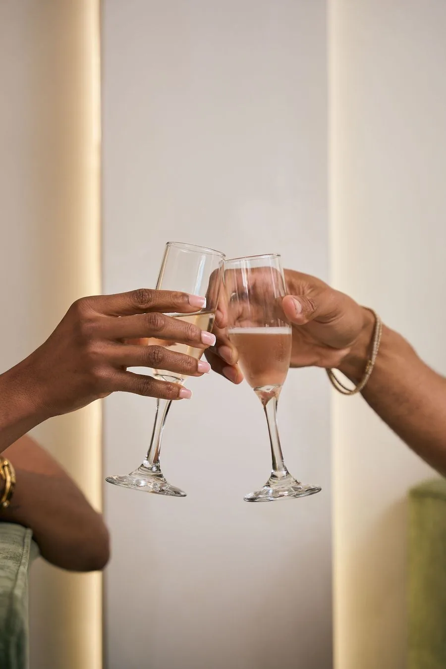 Two glasses raised in a toast at Earth Nail Spa