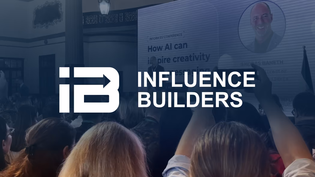 Audience at a conference with a screen showing a speaker and the Influence Builders logo overlayed.