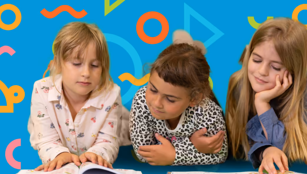 Three young girls lying down reading books against a bright blue background with colorful shapes.