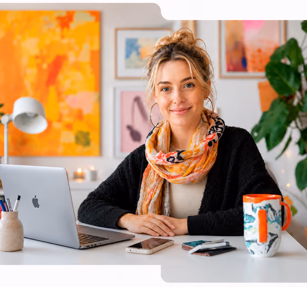 Woman seated at an office desk beside a laptop