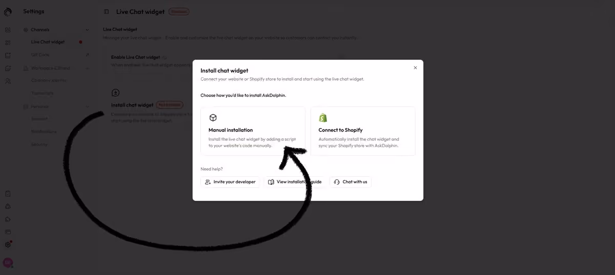 AskDolphin Install chat widget window with two options, Manual installation and Connect to Shopify, and an arrow pointing to Manual installation.