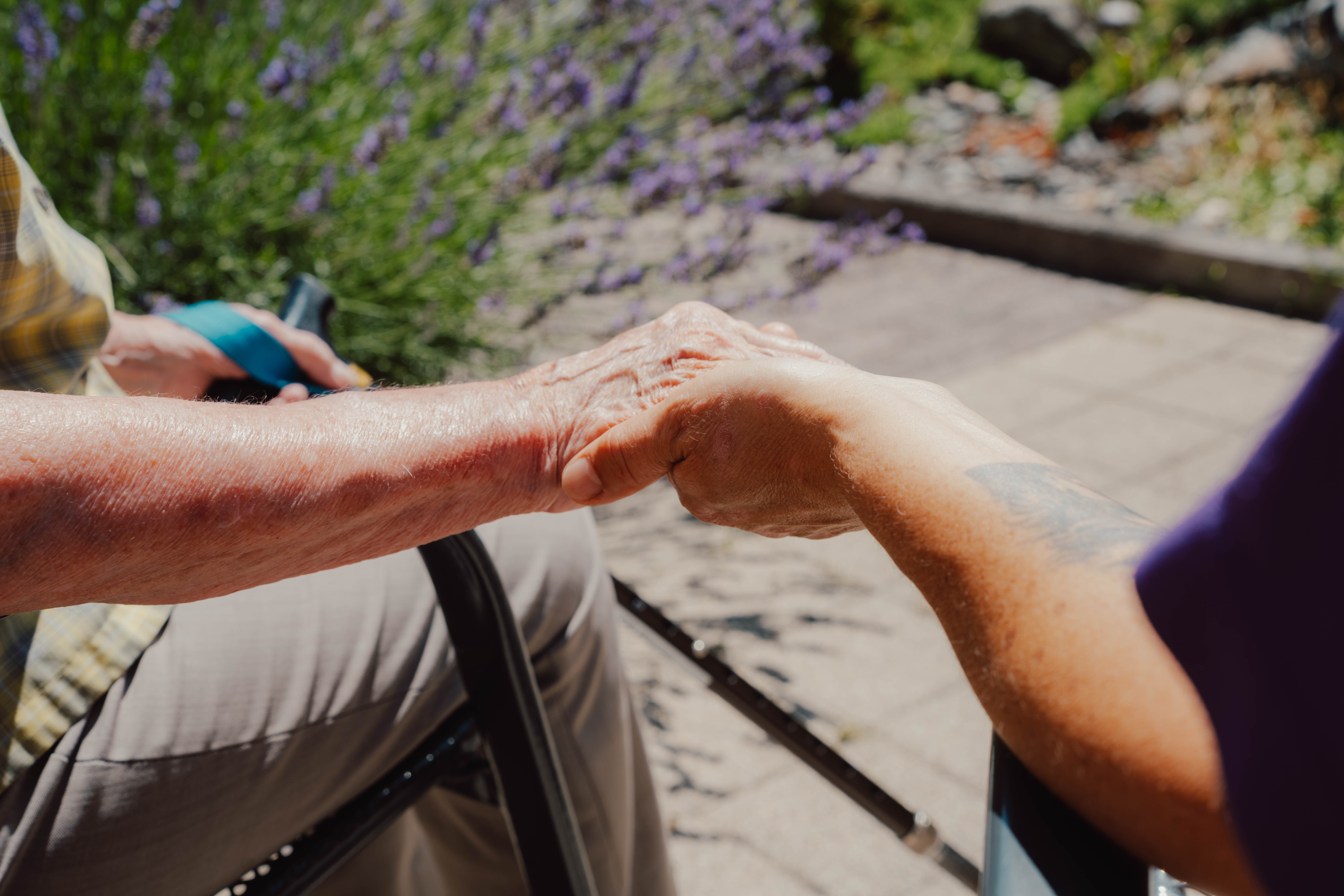 Caregiver holding the hands of a resident