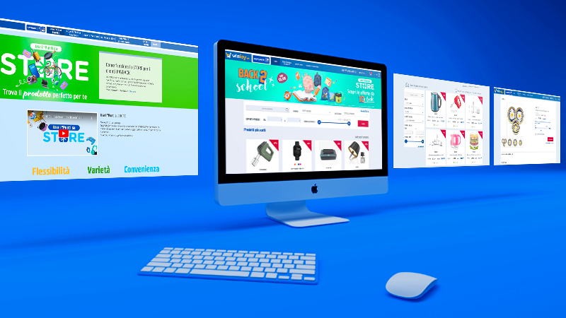 Computer con sito e-commerce per prodotti vari, tastiera e mouse su sfondo blu.