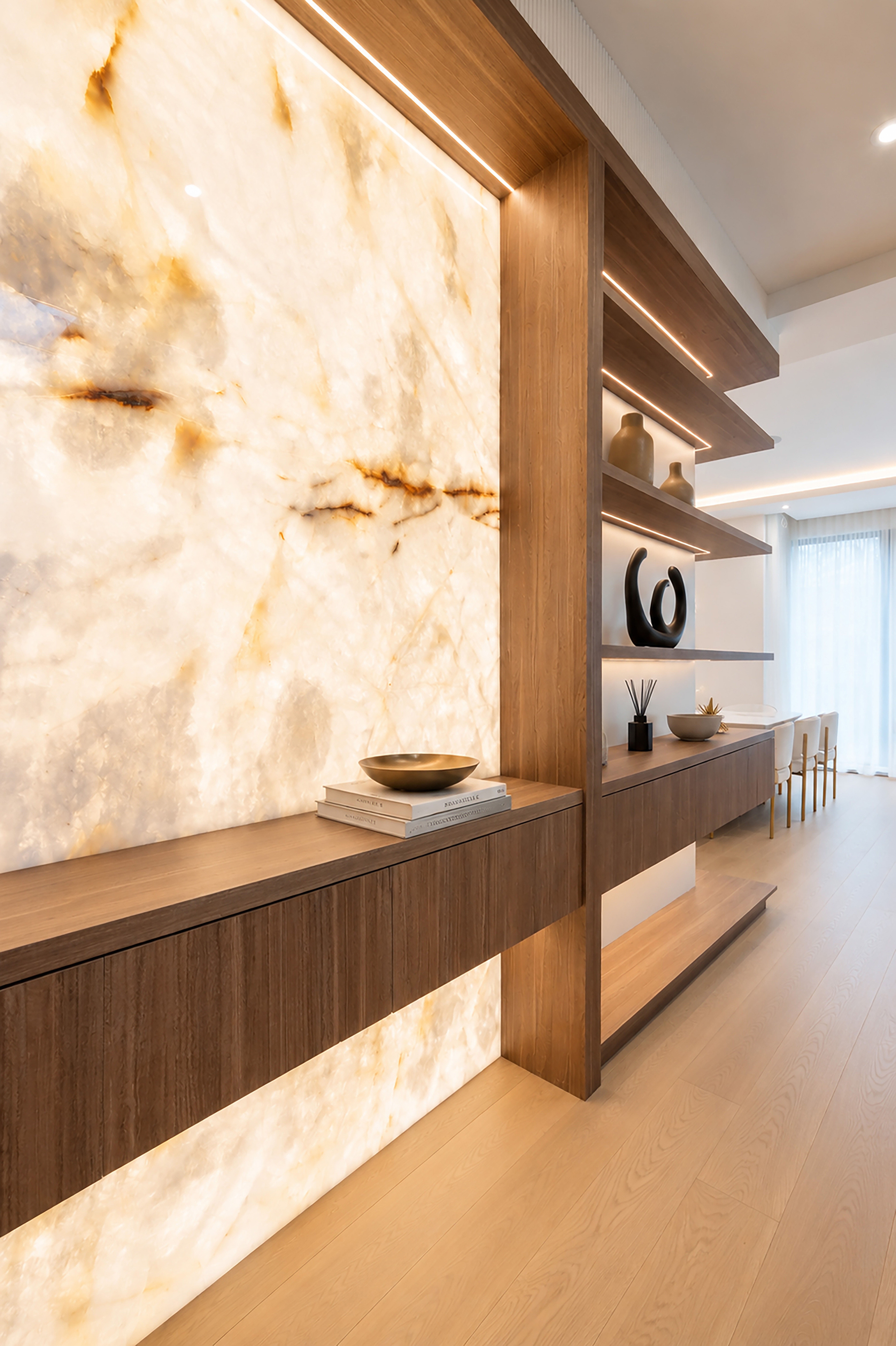 Close-up of backlit stone feature wall and custom wood console