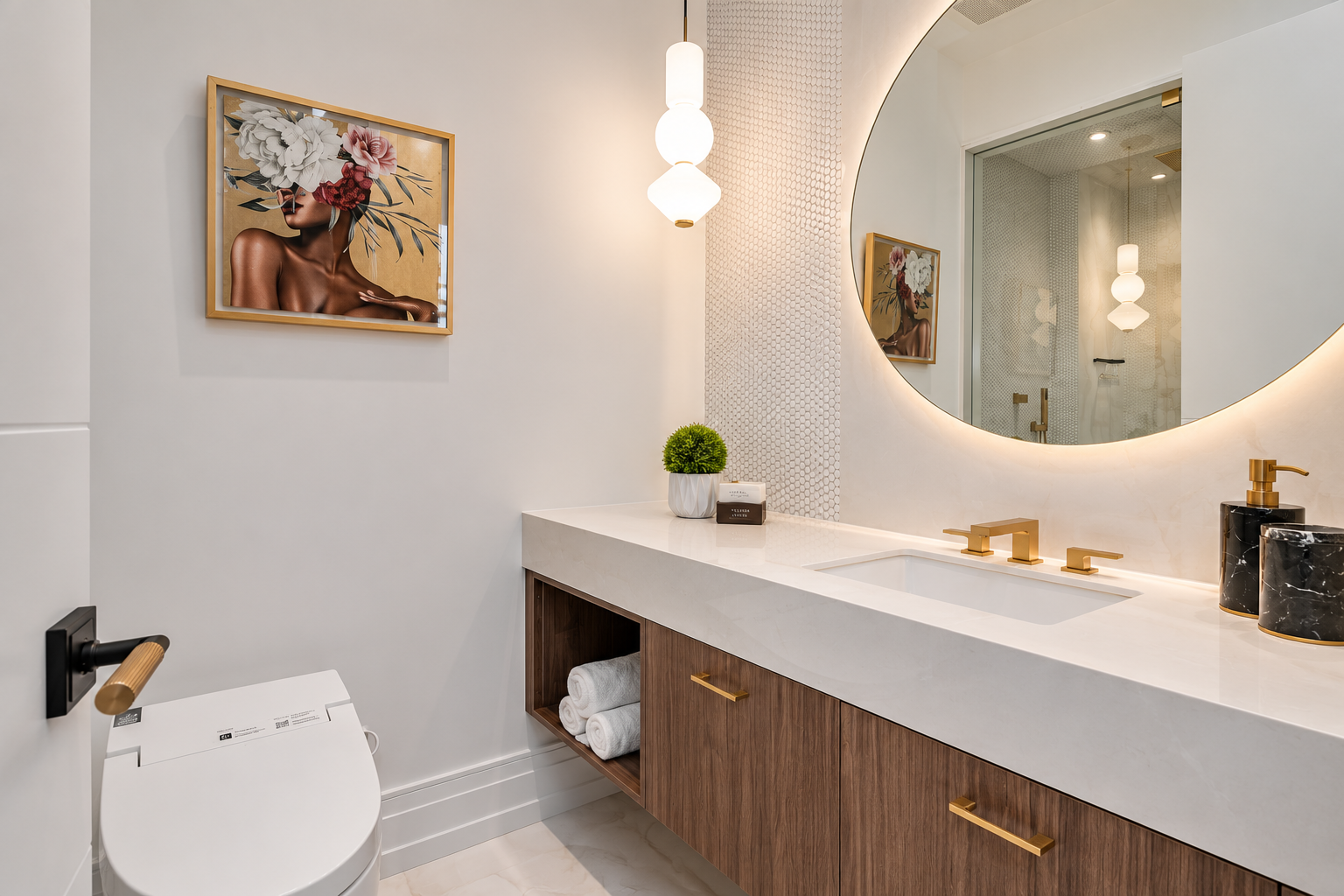 Bathroom vanity with round illuminated mirror, wood cabinetry, white countertop, and gold fixtures