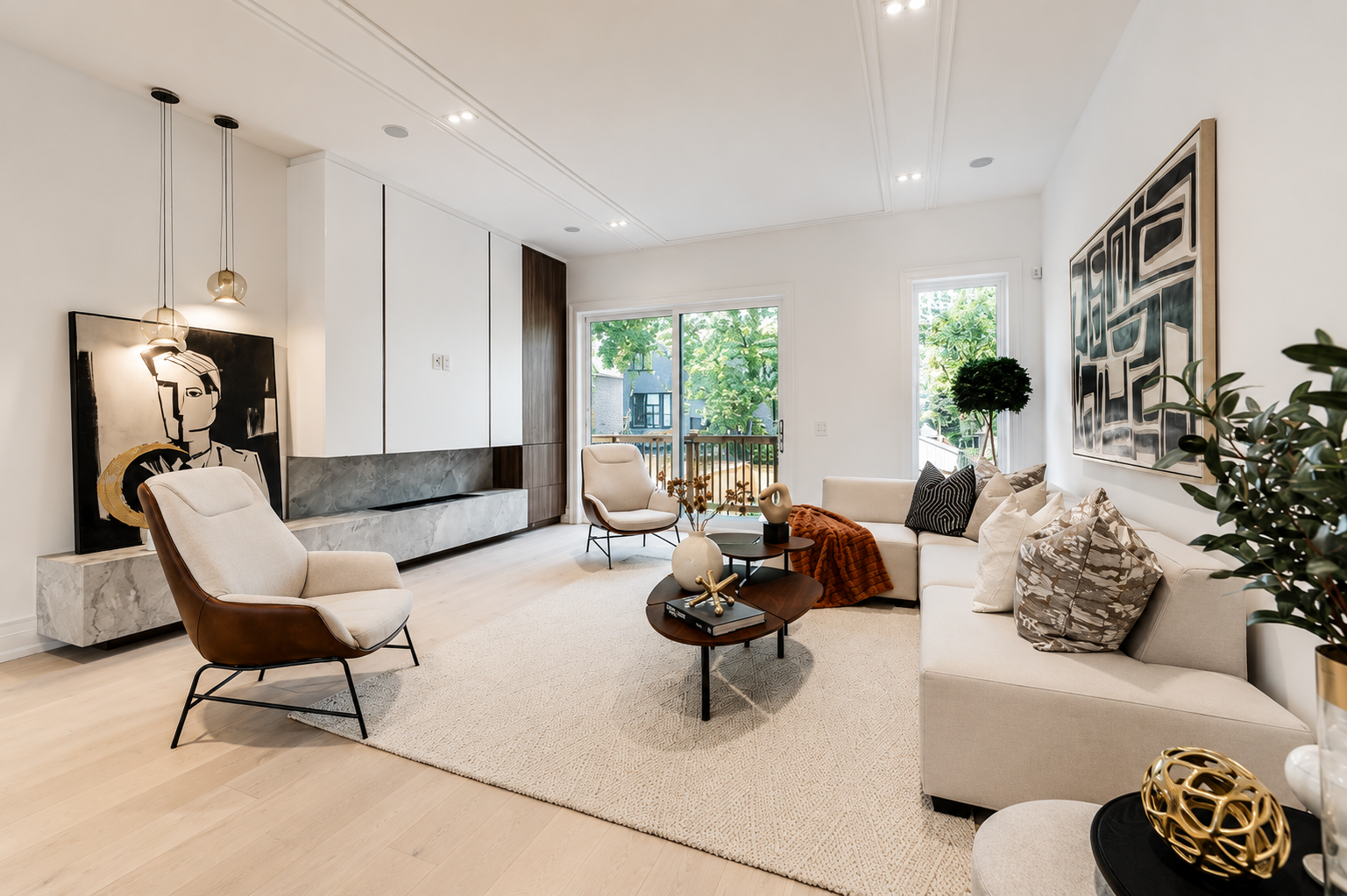 Bright living room with white seating, large artwork, and a long stone feature bench