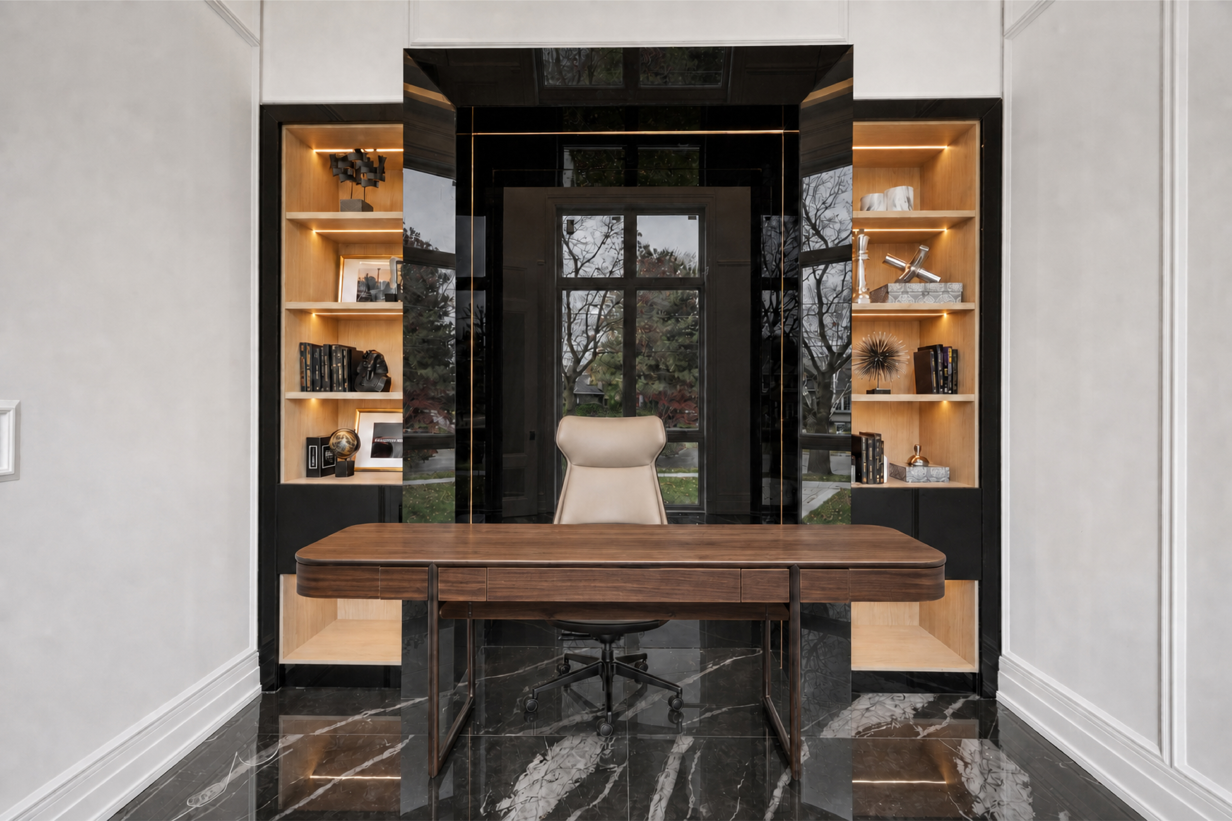 Home office with wood desk, dark reflective wall panels, marble flooring, and built-in shelving