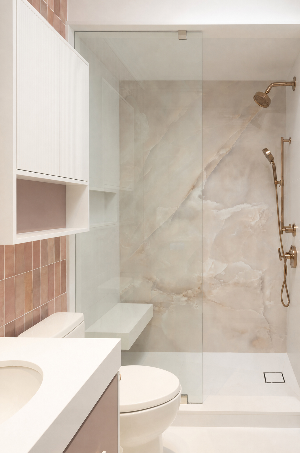 Bathroom shower with large-format stone walls, glass enclosure, and pink tile accents