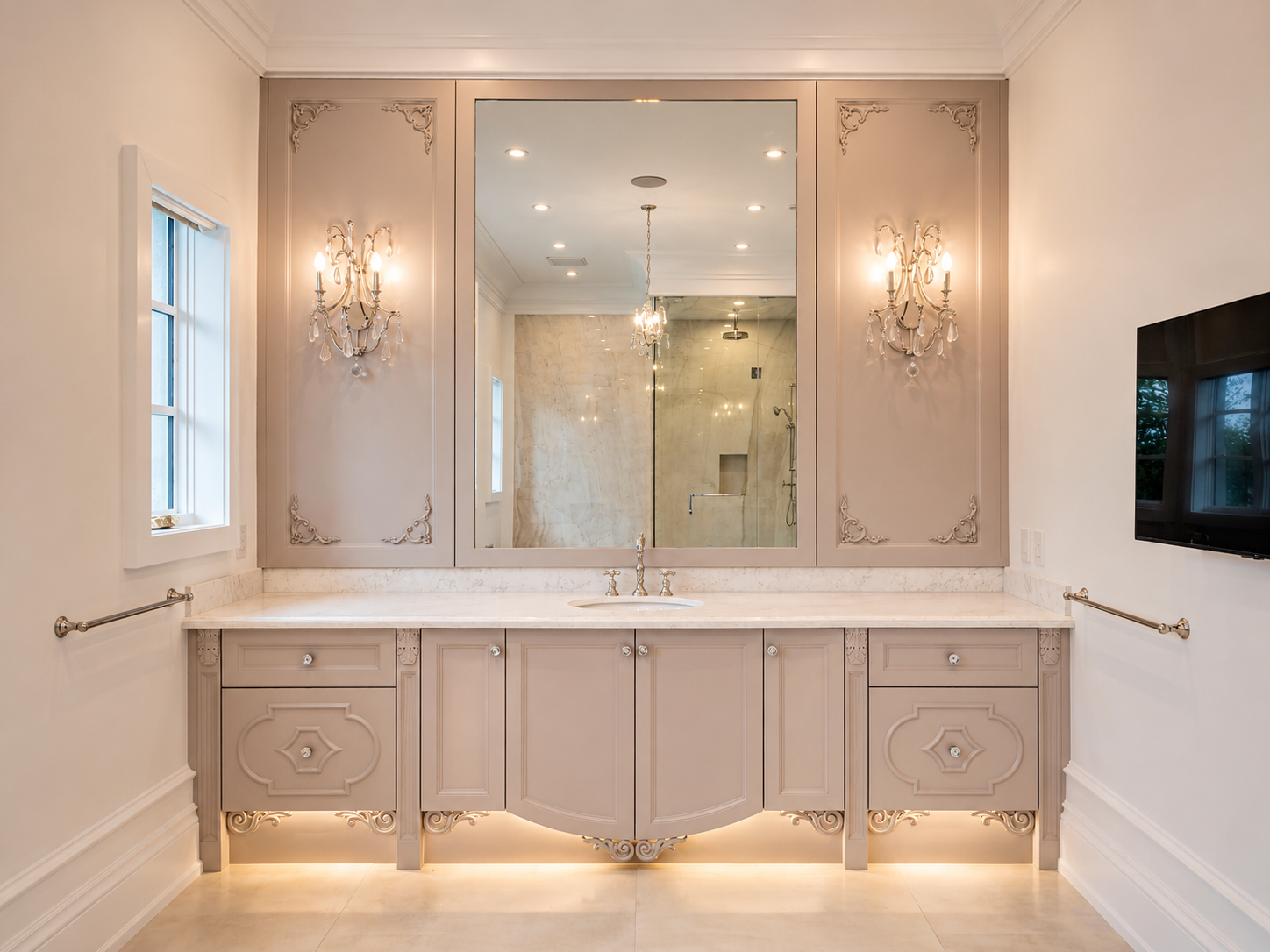 Ornate bathroom vanity with pale cabinetry, large mirror, crystal sconces, and marble countertop