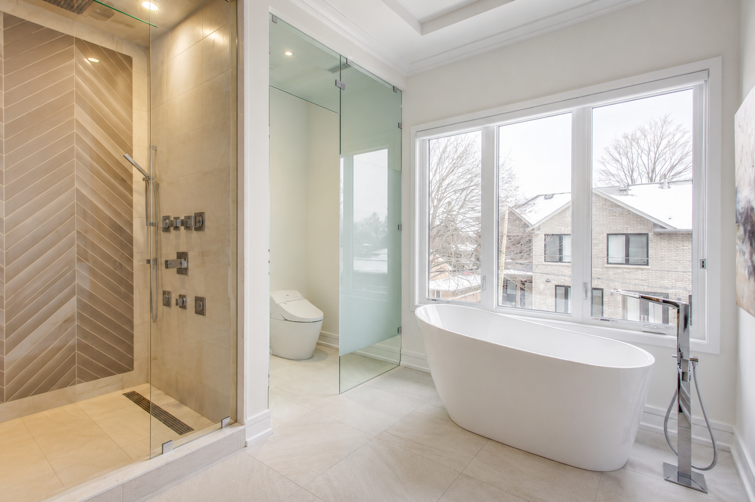 Bathroom with glass shower, freestanding bathtub, large window, and stone finishes