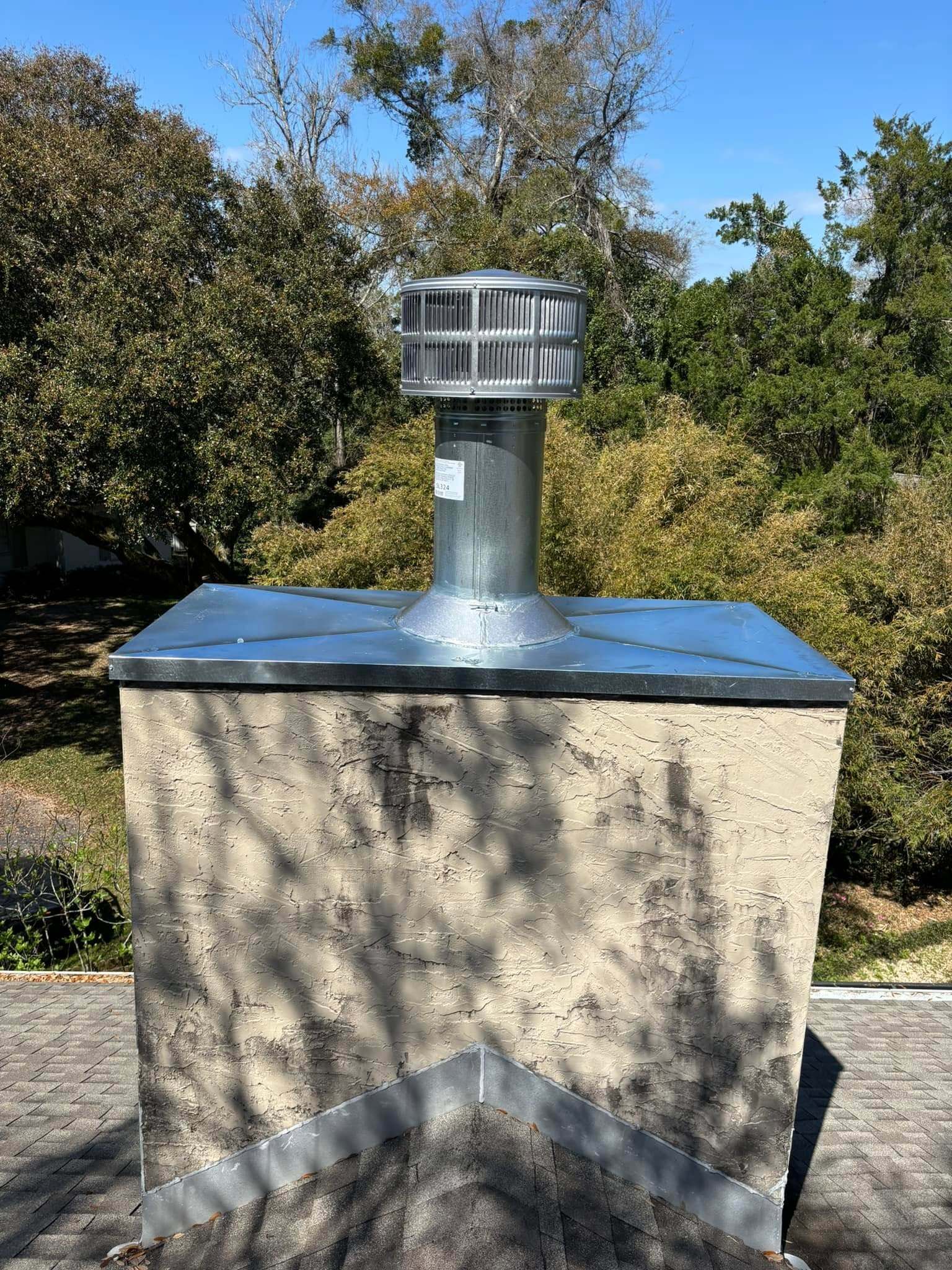 Round chimney termination installed on a chase cover