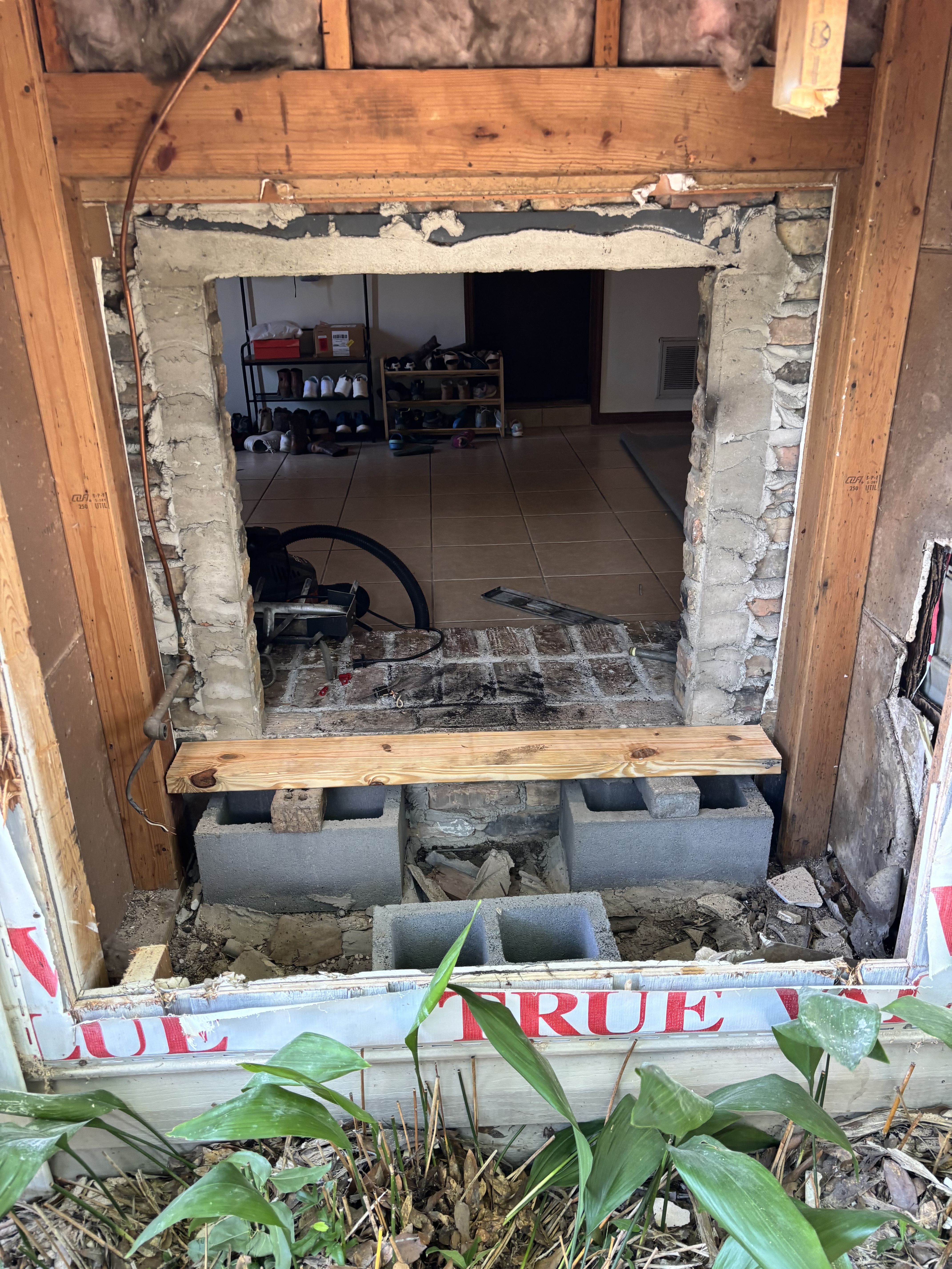 Exterior fireplace opening during rebuild preparation.